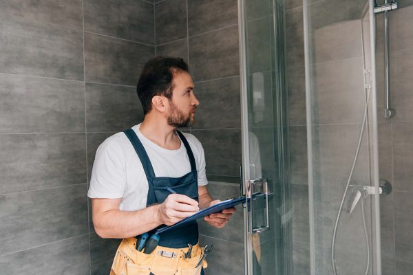 adult-male-plumber-making-notes-in-clipboard-while-resize.jpg adult-male-plumber-making-notes-in-clipboard-while-resize.jpg